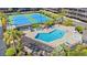 Aerial view of a beautiful pool and tennis courts surrounded by lush landscaping at a condo community at 208 Ocean Blvd. N # 228, North Myrtle Beach, SC 29582