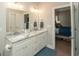 Well-lit bathroom boasts a double sink vanity and offers access to the bedroom, blending convenience and privacy at 220 Gloucester Way, Little River, SC 29566