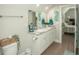 This bathroom has dual sinks, a marble countertop, stylish decor, and an adjacent bedroom at 220 Gloucester Way, Little River, SC 29566