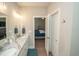 Bright bathroom with double vanity sink and seamless access to the nearby bedroom, offering both functionality and style at 220 Gloucester Way, Little River, SC 29566
