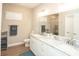 Elegant bathroom featuring double vanity sinks, marble countertops, and a tiled walk-in shower with seamless glass door at 220 Gloucester Way, Little River, SC 29566