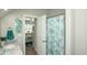 This stylish bathroom features a marble countertop and a patterned shower curtain, and an adjacent bedroom at 220 Gloucester Way, Little River, SC 29566