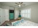 This bedroom features plantation shutters, a ceiling fan, colorful decor, and an ensuite bathroom at 220 Gloucester Way, Little River, SC 29566
