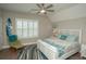 This beautifully decorated bedroom features plantation shutters, coastal-themed decor, and a ceiling fan at 220 Gloucester Way, Little River, SC 29566