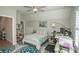 This bedroom features a ceiling fan, a desk, and a comfortable bed, perfect for relaxing or working at 220 Gloucester Way, Little River, SC 29566