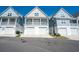Charming beach home with white garage doors and a cozy second story porch at 220 Gloucester Way, Little River, SC 29566