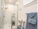 Tiled walk-in shower features stylish fixtures, a built-in bench, and clear glass doors for a luxurious showering experience at 220 Gloucester Way, Little River, SC 29566
