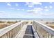 Boardwalk leading to sandy beach with ocean and sky view at 2201 S Ocean Blvd. # 707, Myrtle Beach, SC 29577