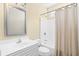 Bright bathroom featuring a vanity with sink, toilet, and a shower-tub combo with curtain at 2213 Gazebo Ct., North Myrtle Beach, SC 29582