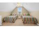 Attic bedroom with two twin beds and a shared nightstand is bathed in natural light at 2213 Gazebo Ct., North Myrtle Beach, SC 29582