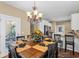 Elegant dining area with stylish chandelier, table setting, and a view into the kitchen at 2213 Gazebo Ct., North Myrtle Beach, SC 29582