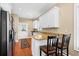 Bright kitchen featuring granite countertops, wood flooring, and view to dining area at 2213 Gazebo Ct., North Myrtle Beach, SC 29582