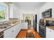 Charming kitchen featuring stainless steel appliances, granite countertops, and wood flooring at 2213 Gazebo Ct., North Myrtle Beach, SC 29582