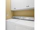Functional laundry room with a washer, dryer, and overhead cabinets for storage at 2213 Gazebo Ct., North Myrtle Beach, SC 29582