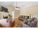 Spacious living room with a fireplace, hardwood floors, and a comfortable seating arrangement at 2213 Gazebo Ct., North Myrtle Beach, SC 29582