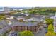 Aerial view of multi-story condo building near marshland, golf course, and ocean at 223 Maison Dr. # F-12, Myrtle Beach, SC 29572