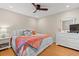 Bedroom with ceiling fan and a comfortable bed featuring a variety of colorful pillows at 223 Maison Dr. # F-12, Myrtle Beach, SC 29572