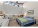 Bedroom with vaulted ceilings, fan, and a bed dressed in blue patterned bedding at 223 Maison Dr. # F-12, Myrtle Beach, SC 29572