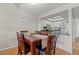 Charming dining area adjacent to the kitchen with wood floors and a table for six at 223 Maison Dr. # F-12, Myrtle Beach, SC 29572