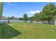 Expansive backyard with lush lawn, play set, patio, and white picket fence at 227 Hickory Springs Ct., Conway, SC 29527