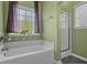 Bathroom with soaking tub, stand up shower and green walls at 227 Hickory Springs Ct., Conway, SC 29527