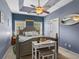 A well lit bedroom with a gray queen bed and a trey ceiling at 227 Hickory Springs Ct., Conway, SC 29527
