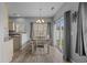 Bright dining area featuring laminate floors, modern chandelier, and sliding glass doors to the outside at 227 Hickory Springs Ct., Conway, SC 29527