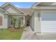 This home features a welcoming entrance, attached garage, and manicured landscaping at 227 Hickory Springs Ct., Conway, SC 29527