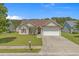 Traditional-style home boasting 2-car garage, established lawn, and mature tree in a sunny setting at 227 Hickory Springs Ct., Conway, SC 29527