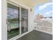 An outside view from a balcony with a sliding glass door and a peek of other buildings at 2406 S Ocean Blvd. # 301, North Myrtle Beach, SC 29582