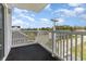 Balcony with white railings overlooking the street and a beautiful sky at 2406 S Ocean Blvd. # 301, North Myrtle Beach, SC 29582