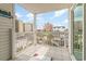 Cozy balcony view showcasing tile floors, white railing, and cityscape with blue sky at 2406 S Ocean Blvd. # 301, North Myrtle Beach, SC 29582