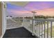 Balcony with white railings overlooking the street and a beautiful sunset sky at 2406 S Ocean Blvd. # 301, North Myrtle Beach, SC 29582