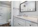 Bright bathroom with white marble countertop vanity and shower with sliding glass door at 2406 S Ocean Blvd. # 301, North Myrtle Beach, SC 29582