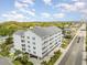 An aerial exterior view showing the side of the condo building with blue shutters and surrounding neighborhood at 2406 S Ocean Blvd. # 301, North Myrtle Beach, SC 29582