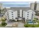 An aerial shot of a white condo building with blue shutters, a pool, and beach access at 2406 S Ocean Blvd. # 301, North Myrtle Beach, SC 29582