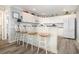 Open kitchen with white cabinets, bar seating, and an airy atmosphere featuring wood-look flooring at 2406 S Ocean Blvd. # 301, North Myrtle Beach, SC 29582