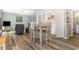 Cozy living space featuring modern flooring, washer/dryer, and a dining area with seating at 2406 S Ocean Blvd. # 301, North Myrtle Beach, SC 29582
