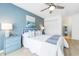 Comfortable bedroom showcasing a queen bed, soft blue accent wall and ample natural light at 245 Egret Run Ln. # 1023, Pawleys Island, SC 29585