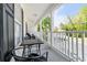 Inviting covered porch with seating, a perfect spot to enjoy the outdoors and relax in comfort at 245 Egret Run Ln. # 1023, Pawleys Island, SC 29585