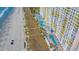 Aerial view of pools with palm trees and beach side access to the condo at 2711 Ocean Blvd. S # 915, North Myrtle Beach, SC 29582