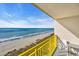 Gorgeous ocean view balcony featuring chairs and bright yellow metal railing at 2711 Ocean Blvd. S # 915, North Myrtle Beach, SC 29582