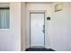 Exterior image of a white apartment door with silver hardware and the unit number, 915, on a blue sign at 2711 Ocean Blvd. S # 915, North Myrtle Beach, SC 29582