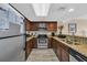 Functional kitchen with stainless steel appliances, dark wood cabinetry, and granite countertops at 2711 Ocean Blvd. S # 915, North Myrtle Beach, SC 29582