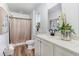 Bright bathroom with a single sink vanity, decorative elements and a neutral-toned shower curtain at 3019 Woodbury Ct., Conway, SC 29527