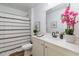 Inviting bathroom with decorative accents, a shower, and a sleek single sink vanity at 3019 Woodbury Ct., Conway, SC 29527