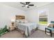 Cozy bedroom featuring a colorful wooden headboard, soft carpeting, and a bright window view at 3019 Woodbury Ct., Conway, SC 29527
