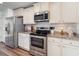 Kitchen features stainless steel appliances, granite countertops, and white cabinetry at 3019 Woodbury Ct., Conway, SC 29527