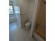 Bright bathroom featuring a white toilet, window, and shower-tub combo with chrome hardware at 302 St. Andrews Ln., Myrtle Beach, SC 29588
