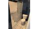 Well-lit bathroom featuring a walk-in shower with glass door and blue tiled walls, plus tiled floors and white toilet at 302 St. Andrews Ln., Myrtle Beach, SC 29588
